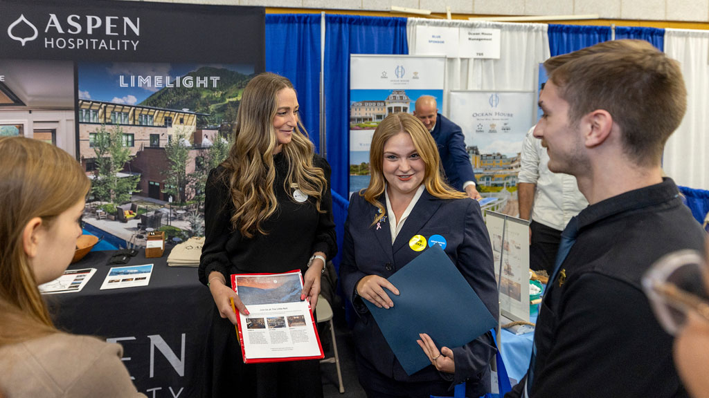 Antoinette Jacques networking with a representative from Aspen Hospitality and students who attended the fair.from at the Fall 2025 Food & Hospitality Industry Career Fair