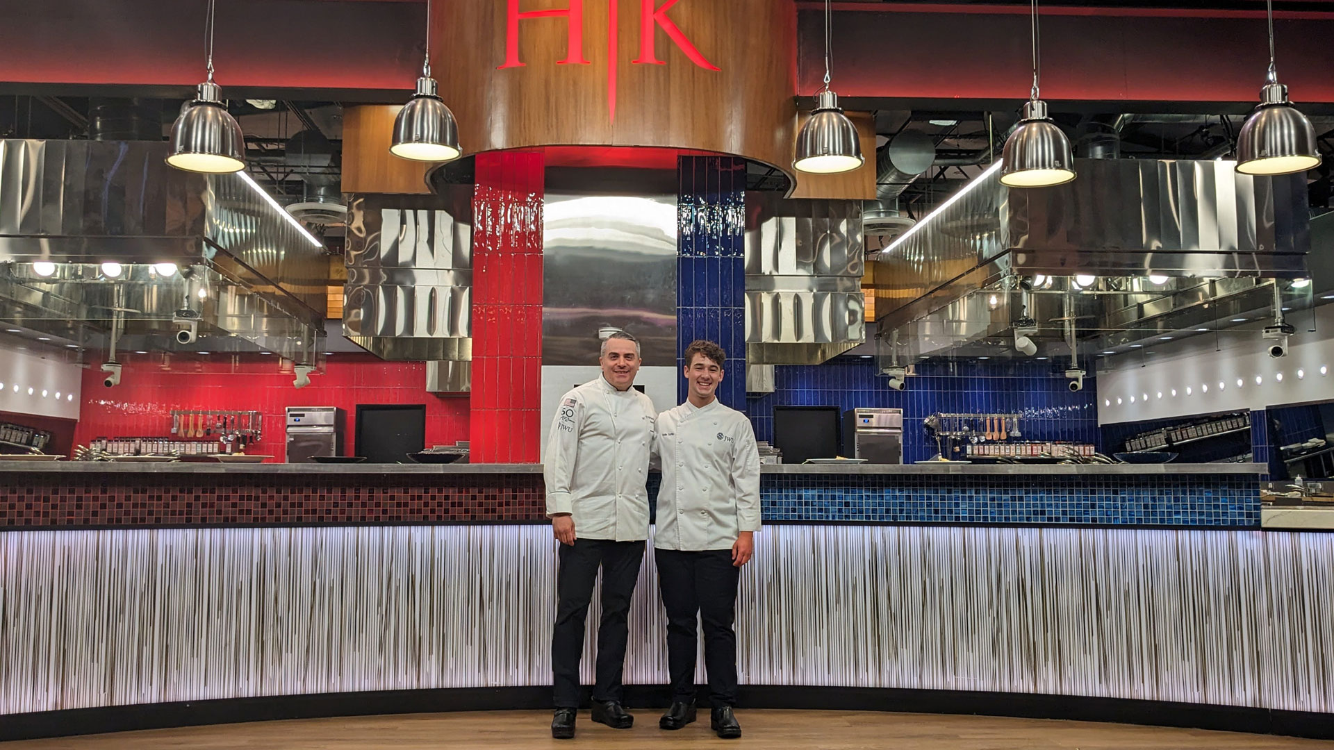 Assistant Dean T.J. Delle Donne and CFIT student Hollis Tuffile '26 on the Hellu2019s Kitchen set.