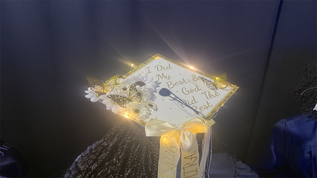Elmira Green showing off religious themed grad cap with lights