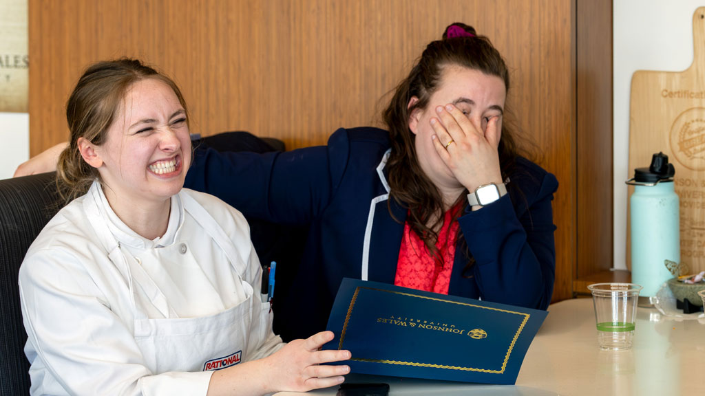 A jubilant Evan LeSuer with her high school culinary teacher.