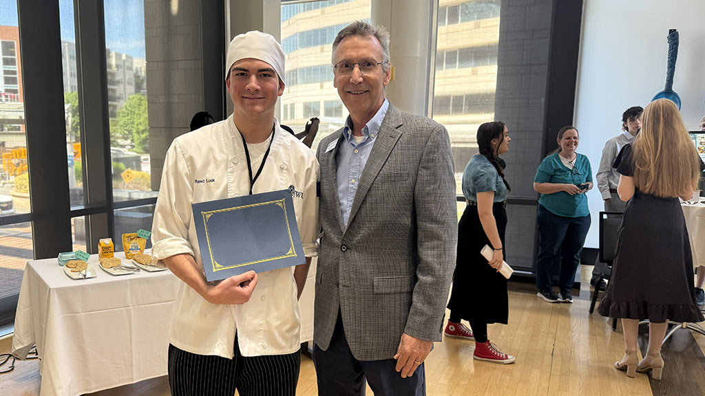 Reed Lusk poses with JWU Charlotte President Mathieu