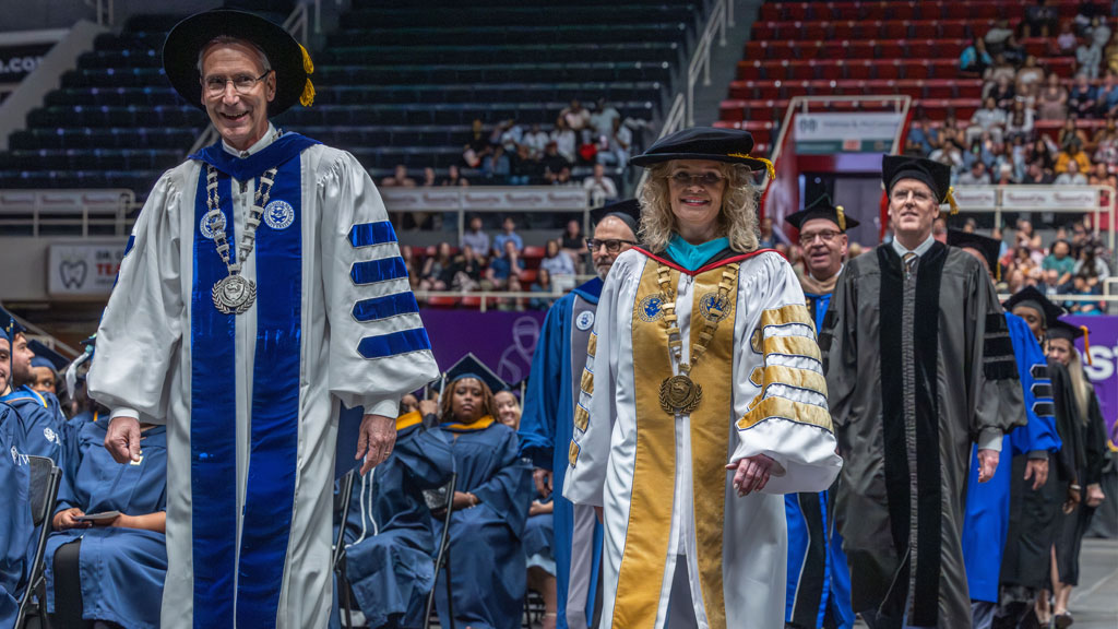 President Mathieu, Chancellor Runey, Provost Wiscott and faculty process towards the stage. 