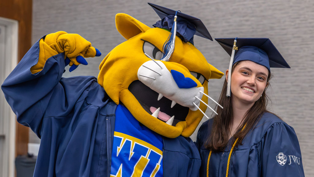 Wildcat Willie poses with a new Charlotte grad.