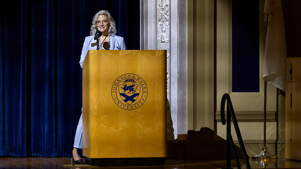 OTD program director Nancy Dooley speaks at a podium