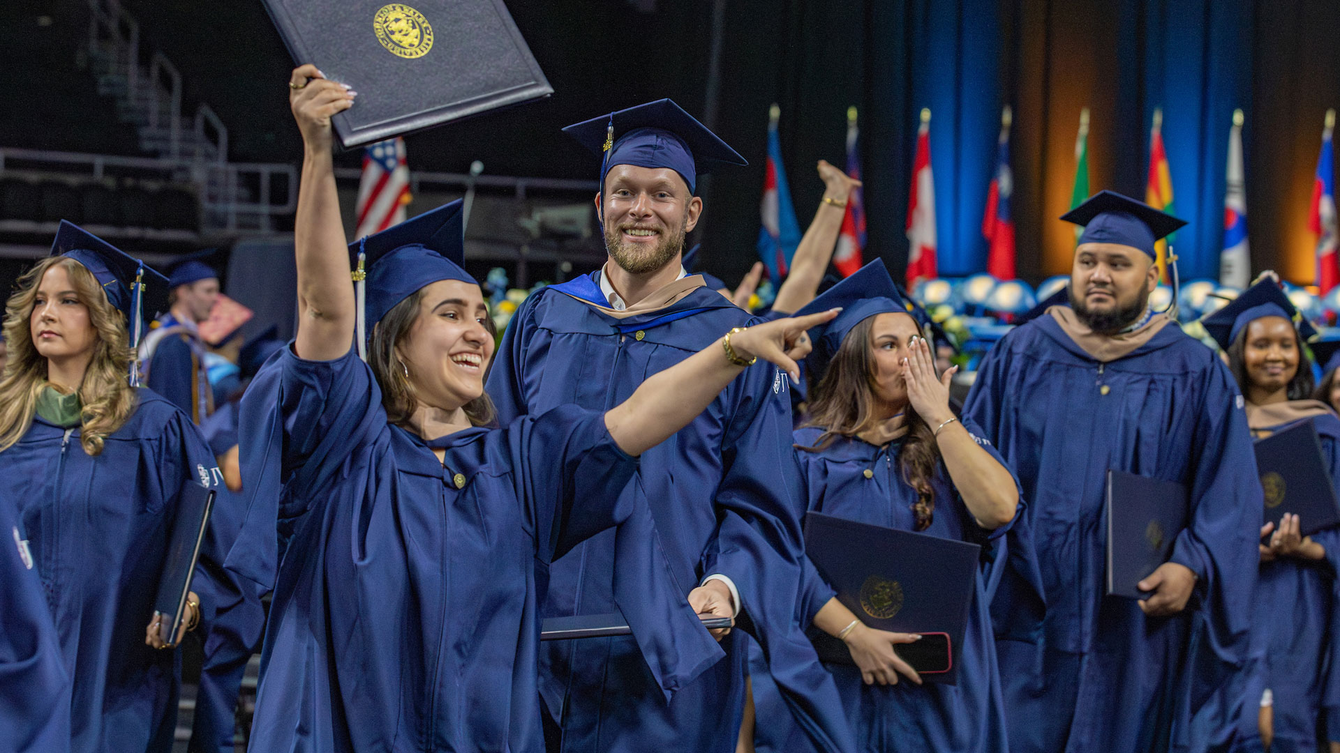 A group of jubilant grads with their diplomas.