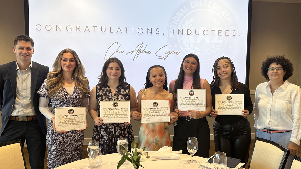 Abigail Rendock and other student members of Chi Alpha Sigma.