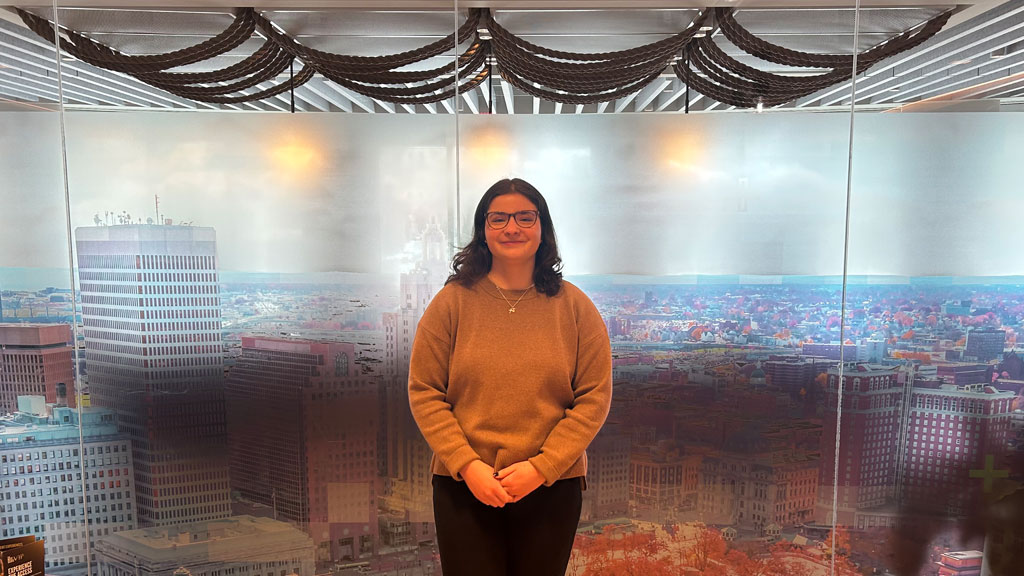 Rendock inside Withum office building in front of an aerial view image of Downcity Providence.