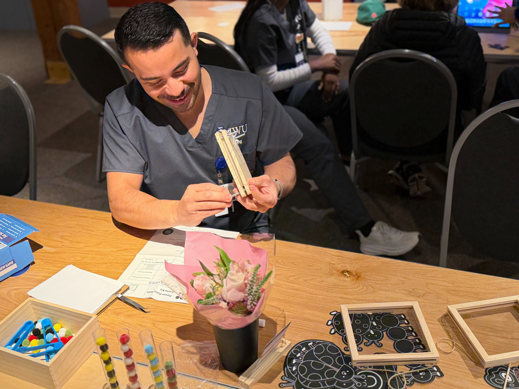 A JWU student offers respite care to a dementia patient at an event in May 2026