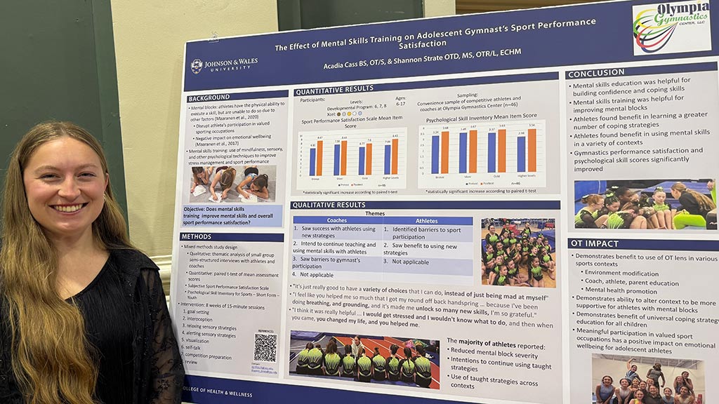 Acadia Cass '26 OTD with her capstone poster
