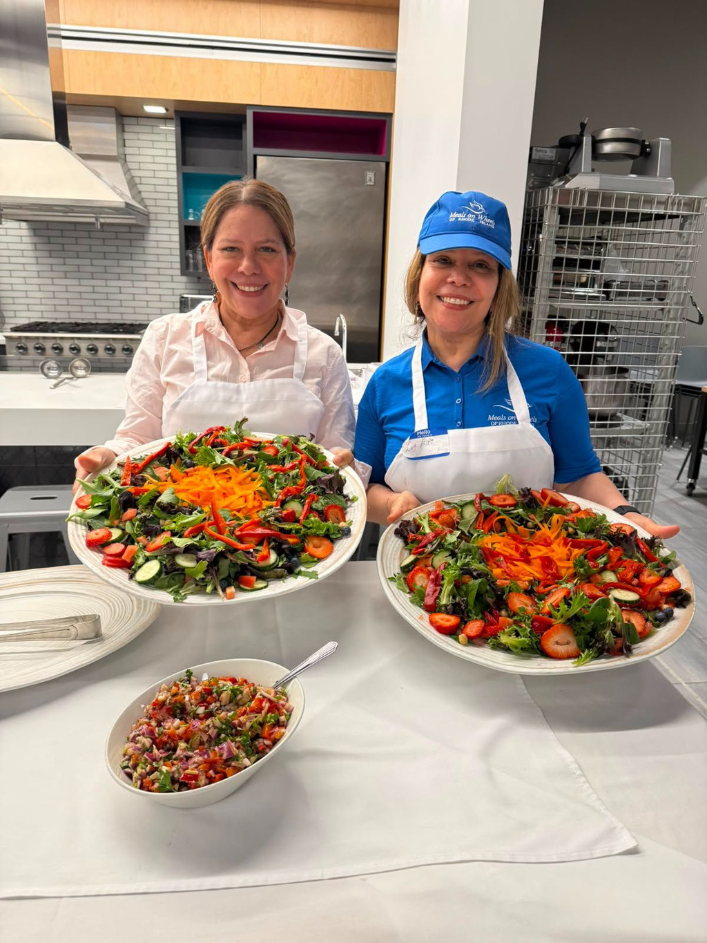 Two caregivers in the kitchen at JWU's May 2026 respite caregiver event on the Harborside Campus