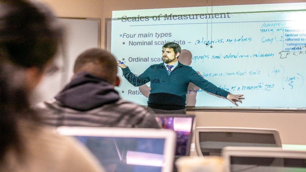 Professor teaching scales of measurement
