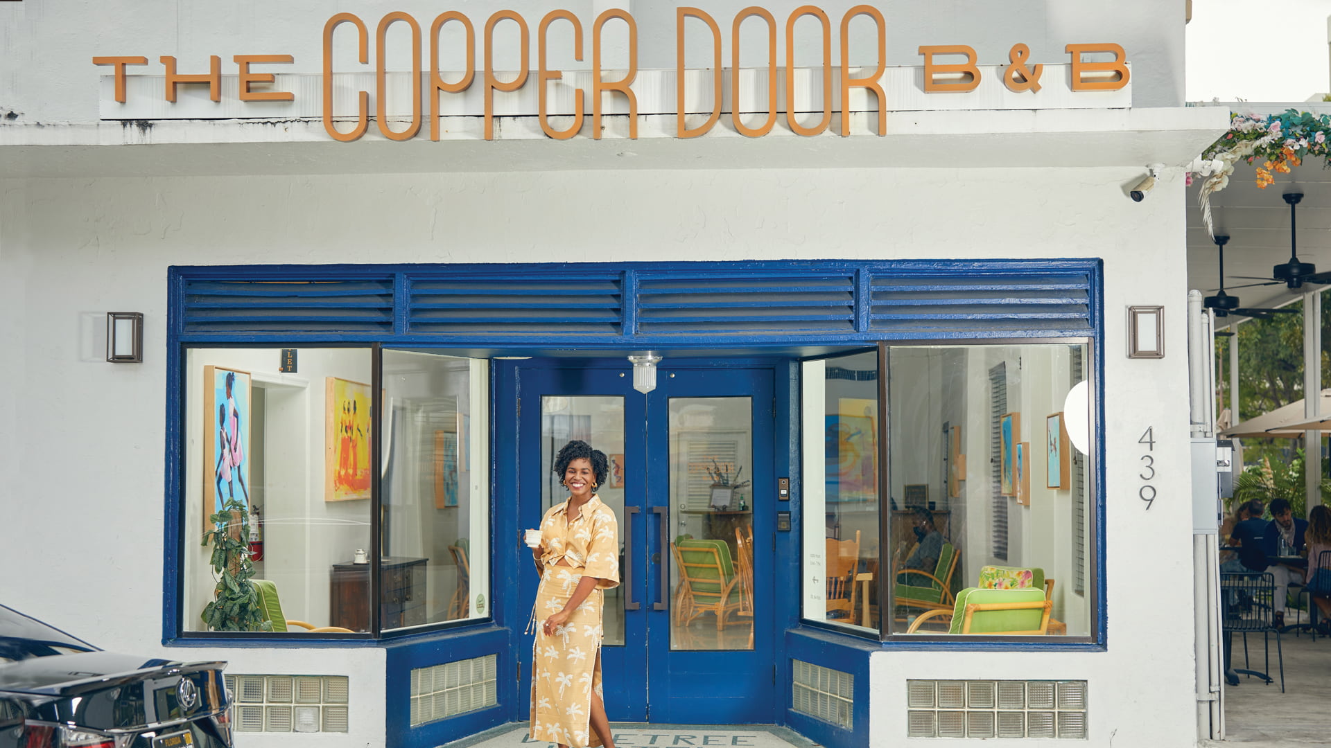 Exterior of The Copper Door with the owner outside